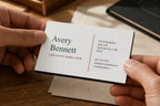 Hands holding a personalized editorial business card with a thick black core