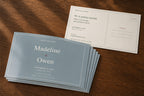 Stack of personalized 4 by 6 save-the-date postcards with the designed front and mailing back visible