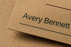 Macro close-up of dark green printing and visible recycled fibers on natural kraft paper