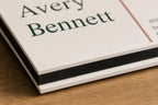 Macro close-up of velvety white business-card faces and a solid black center layer