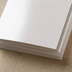 A stack of blank 5x7 cards on 14pt Signature Gloss, showing the bright white surface and the stacked edges